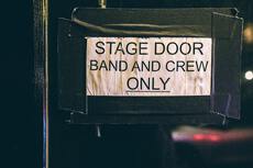 door sign with "stage door band and crew only" written on
it